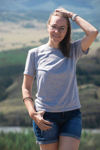 Portrait of smiling young woman standing outdoors