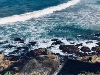 High angle view of rocks at sea shore