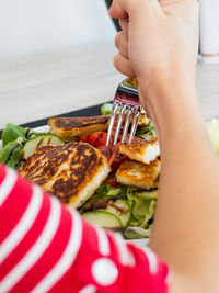 Close-up of person holding food on table