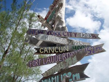 Low angle view of road sign against sky