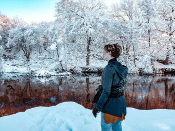 Full length of woman standing on snow covered land