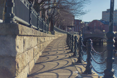 Walkway in city against sky