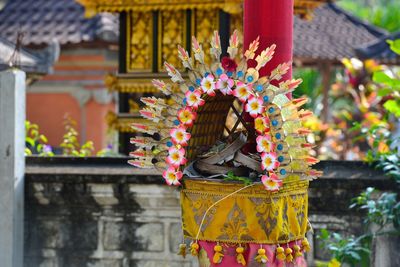 Illuminated statue of flower against building