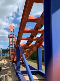 Low angle view of playground against sky seen through window