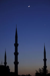 Silhouette of building against blue sky