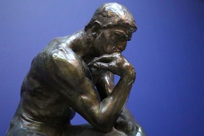 Close-up of statue against blue sky