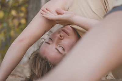 Close-up portrait of young woman lying down