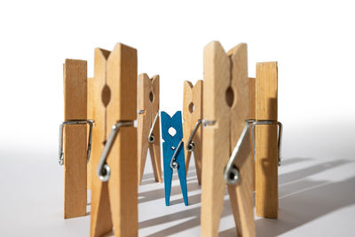 Close-up of clothespins on clothesline against white background