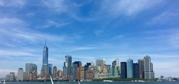 East river against one world trade center amidst towers at manhattan