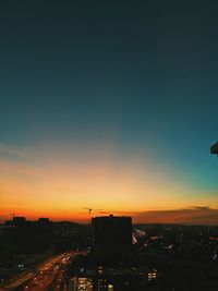 Silhouette cityscape against sky during sunset