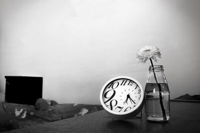 Close-up of clock on table at home