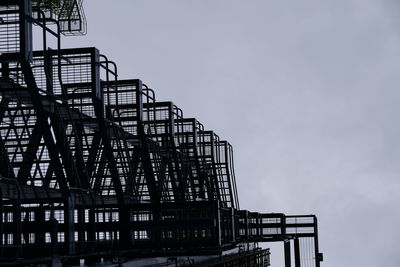 Low angle view of crane against sky