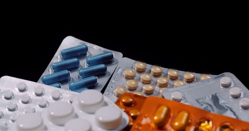 Close-up of pills against black background