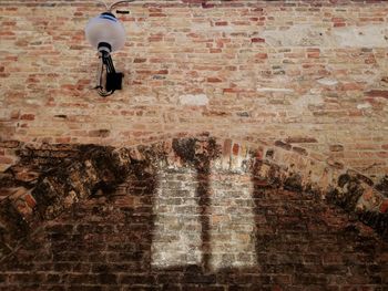 High angle view of man standing by brick wall