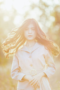 Portrait of a beautiful young woman standing outdoors