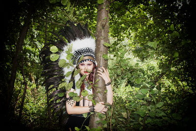 Portrait of woman wearing headdress in forest