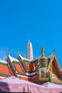 Temple in city against sky