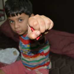 Portrait of boy showing wrist