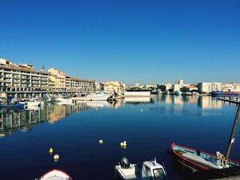 Boats in river with buildings in background