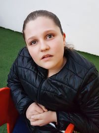 Portrait of boy sitting on sofa