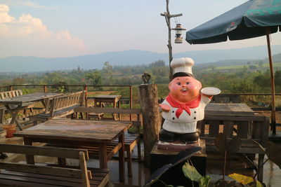 Portrait of stuffed toy on table against sky