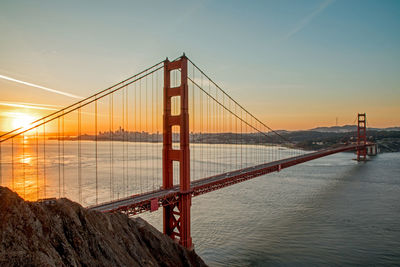 Golden gate bridge over san francisco bay against sky during sunset