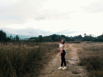 Full length of man standing on field against sky