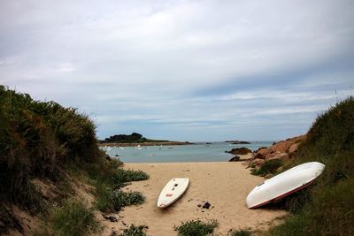 Boats at beach against sky