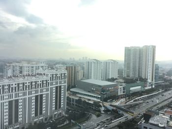 High angle view of buildings in city against sky