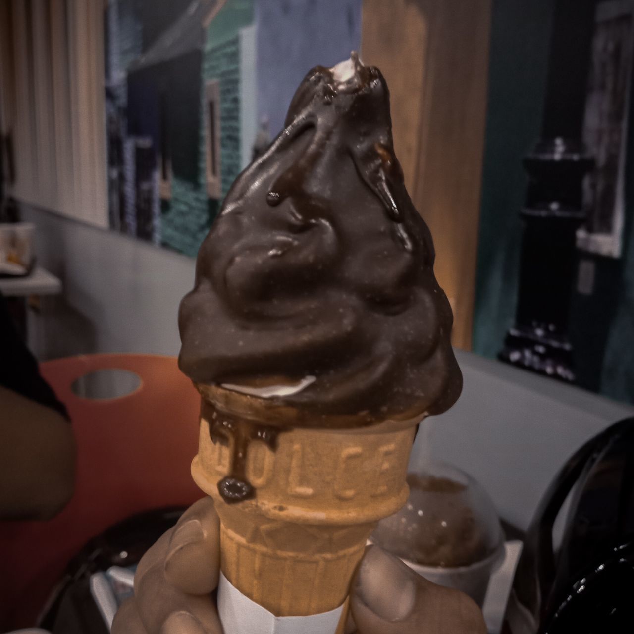 CLOSE-UP OF HUMAN HAND HOLDING ICE CREAM