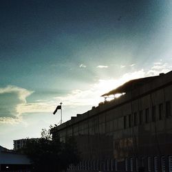 Buildings in city against cloudy sky