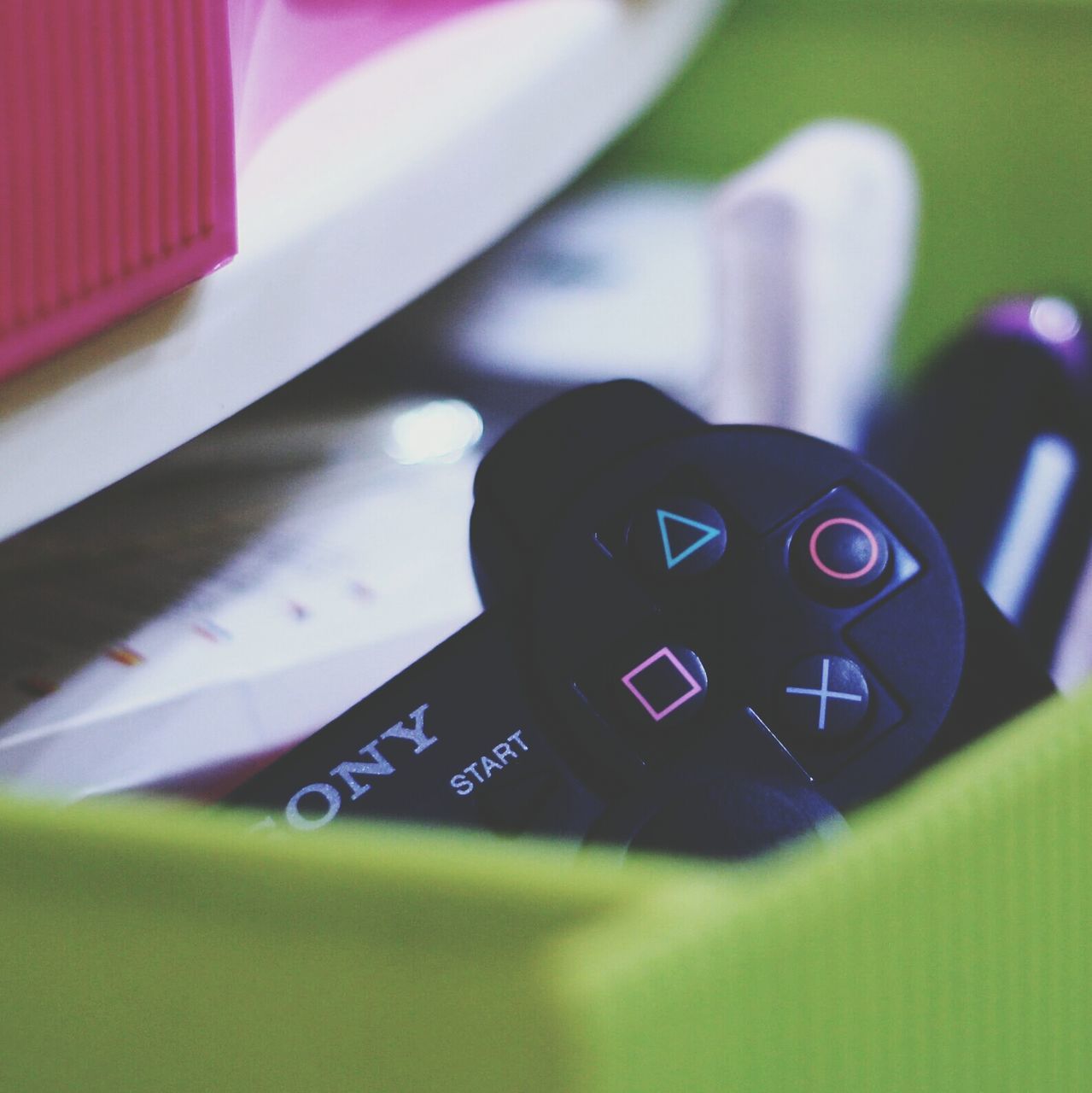 close-up, indoors, communication, technology, focus on foreground, still life, number, text, selective focus, connection, single object, western script, wireless technology, no people, table, green color, toy, metal, high angle view, photography themes