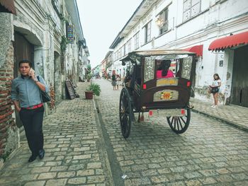 Rear view of woman standing in city