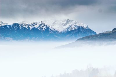 Scenic view of snowcapped mountains against sky