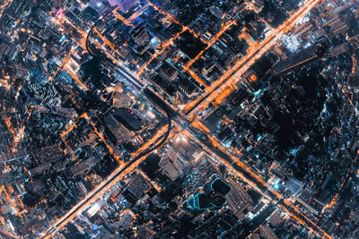 High angle view of city lit up at night