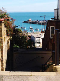 High angle view of buildings by sea against sky