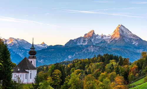 Scenic view of trees and mountains against sky