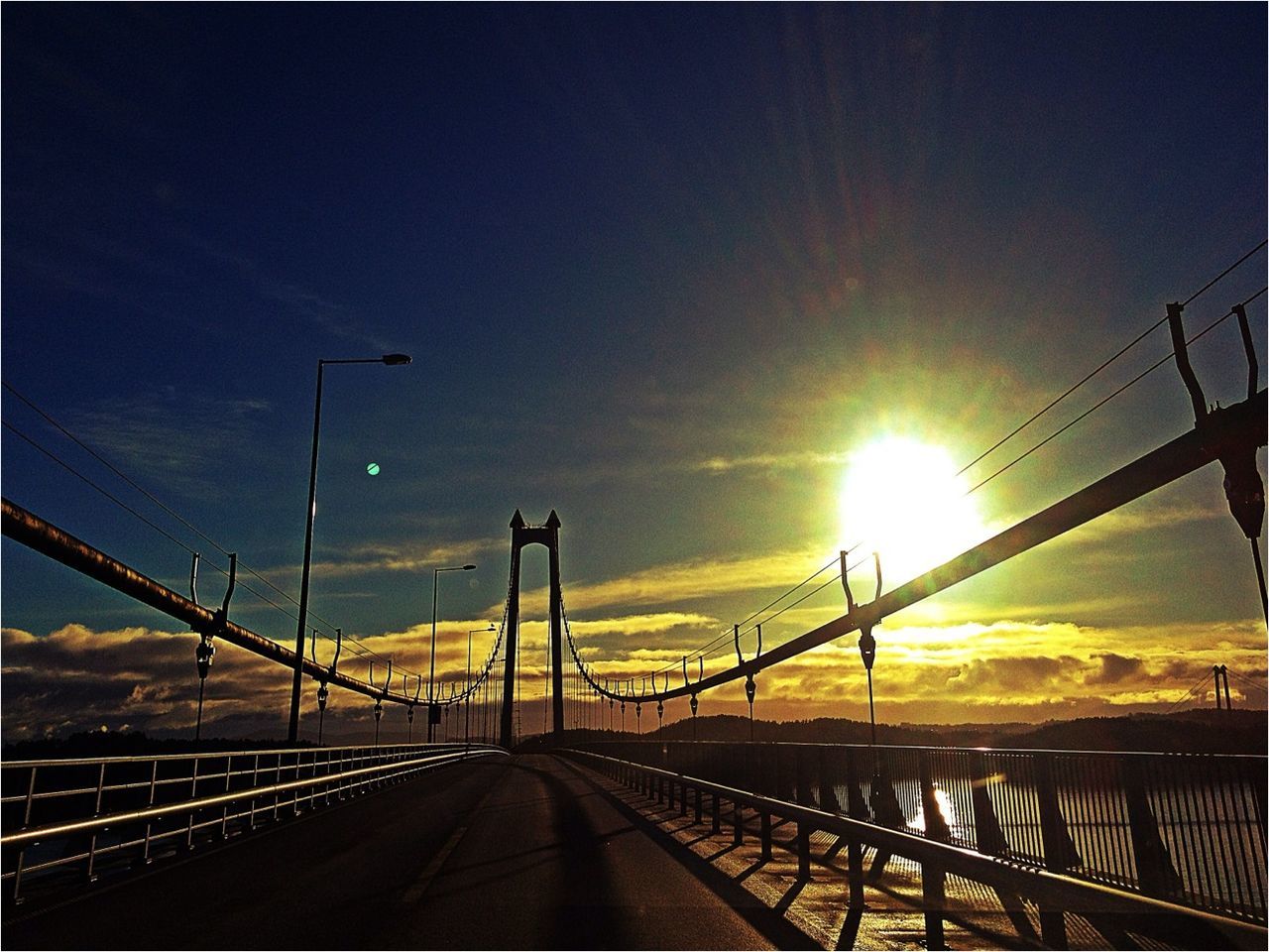 sunset, sun, transportation, the way forward, sky, connection, diminishing perspective, railing, bridge - man made structure, railroad track, vanishing point, road, built structure, sunlight, orange color, sunbeam, lens flare, architecture, rail transportation, cloud - sky