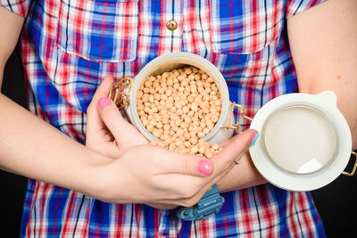 Midsection of woman holding coffee cup