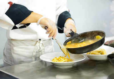 Midsection of man preparing food