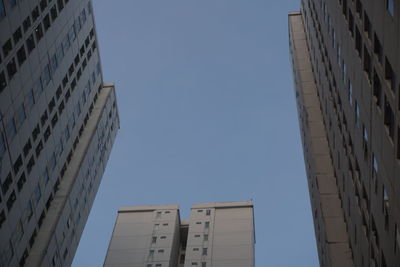 Low angle view of modern buildings against clear blue sky