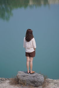  woman standing on rock 