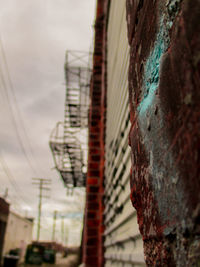 Close-up of man in city against sky