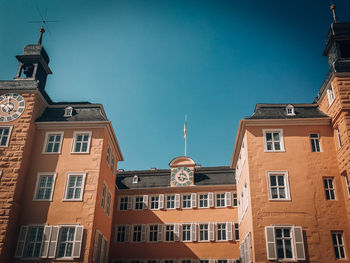 Low angle view of buildings against blue sky