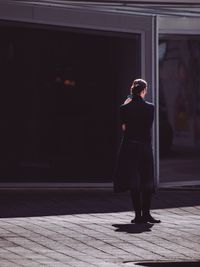 Full length of woman standing by railing