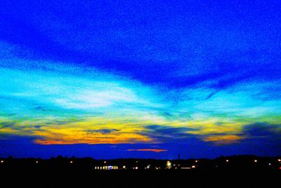 Silhouette illuminated blue sky at sunset