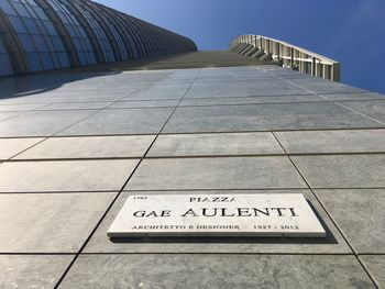 Low angle view of text on building against sky