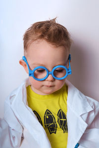 Little explorer. boy plays scientist. funny child with blue glasses. cute, colorful photo. 