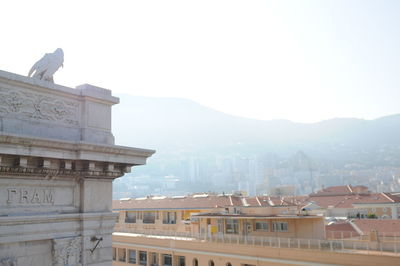 Buildings in city against clear sky