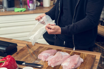 Midsection of person preparing food on table